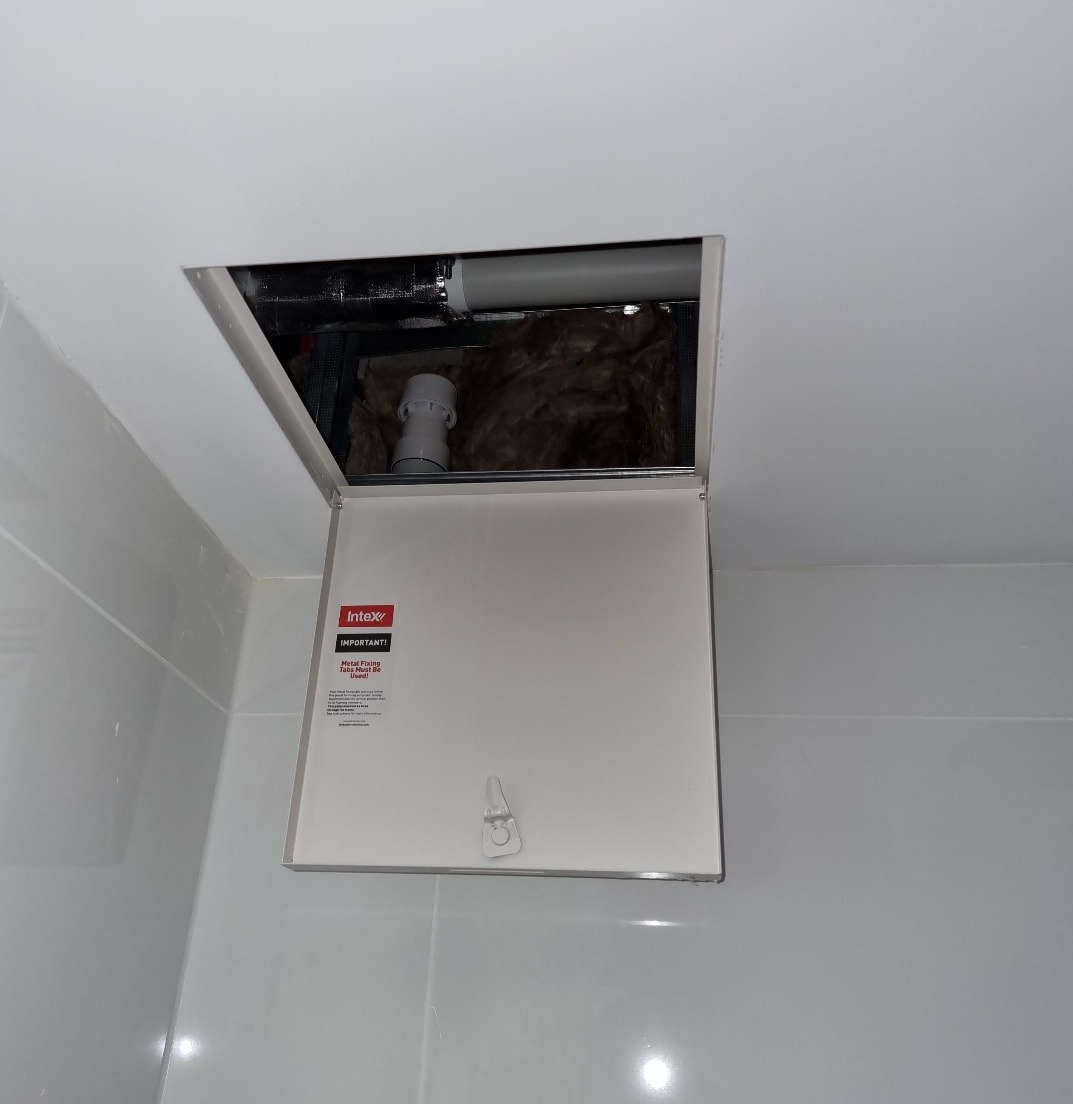 A compliant access panel for means of access to air admittance valve within a ceiling space.
