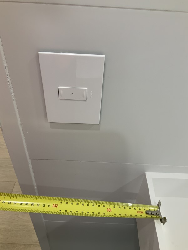 Image of tape measure showing the distance between light switch and basin