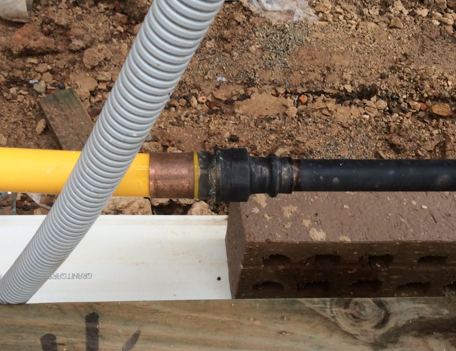 Image example 1: A threaded joiner installed to connect multilayer pipe and copper within a cavity wall, without access and/or ventilation.